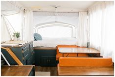 the inside of a camper with two couches and a bed