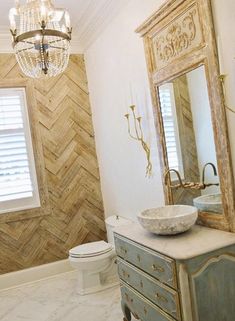 a bathroom with a sink, mirror and toilet in it's centerpieces