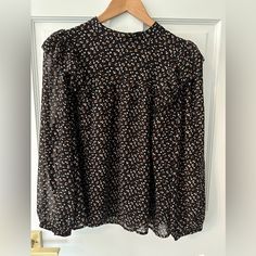 Nwt Madewell Black Floral Ruffle Shoulder Long Sleeve Blouse Sz L Black, White, Brown And Yellow Small Floral Pattern Ruffle Shoulders Long Sleeve Black Lining Button Neck Closure 22 Inch Bust 23.5 Inch Length (Shoulder To Hem) Black Blouse With Ruffled Collar For Fall, Black Ruffled Collar Blouse For Fall, Small Floral Pattern, Black Floral Top, Black Blouse Long Sleeve, Pleated Sleeves, Balloon Sleeve Blouse, Blouse Tank Top, Blouse Sleeveless