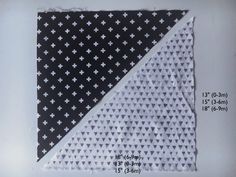 two pieces of fabric with white crosses on black and white background, each piece has one smaller triangle than the other