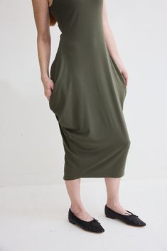 Turn heads in this chic sleeveless dress and its flattering silhouette. Pair with your favorite heels or dress down with casual sneakers. Sleeveless Tapered silhouette Midi length V-neck Modern Green Summer Dress, Casual Sleeveless Knee-length Stretch Dress, Casual Stretch Sleeveless Knee-length Dress, Casual Stretch Midi Dress Longline, Casual Stretch Longline Dresses, Casual Longline Stretch Dresses, Versatile Knee-length Summer Dress, Versatile Sleeveless Stretch Dresses, Versatile Stretch Sleeveless Dress