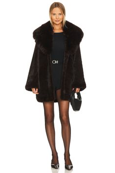 New York-based designer Adrienne Landau juxtaposes glamorous ease and use of color in her signature fur collection. The luxe fur and detailed tailoring have made this line a go-to for the most fashionable and influential women.100% polyester.  Made in China.  Dry clean only.  Front hook and eye closure.  Side seam pockets.  Heavyweight faux fur fabric.  .  .  .  .  .  .  .  .  .  . Black Fur Jacket, Long Faux Fur Coat, Fox Fur Jacket, Fur Jackets, Holiday Attire, Influential Women, Mink Coat, Fur Fabric, Faux Fur Fabric