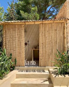 an outdoor shower in the middle of a garden with steps leading up to it and plants around