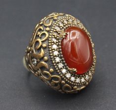 I am offering you beautiful Turkish ottoman silver & Bronze ring. Beautiful glass carnelian stone and lovely zircon beads design. Please do not hesitate to contact if you have any questions. Weight : 27.0 grams,  Ring size 7.5 on US Jewelry ring mandrel  Shipping & Estimated Delivery Time With Turkish Registered Post, Destination CountryStandard Shipping (business days) United States 15-20  Europe7-15 Asia15-25  Australia15-20 Brazil & South America Ottoman Silver, Ring Mandrel, Turkish Ottoman, Beads Design, Tibetan Jewelry, Carved Ring, Large Necklace, Turquoise Bead Necklaces, Coin Earrings