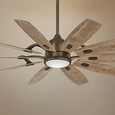 a ceiling fan with five wooden blades hanging from it's center point and two light bulbs on each side