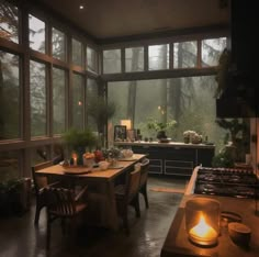 a kitchen filled with lots of windows next to a stove top oven and counter top