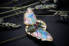 This cicada or butterfly brooch needle makes the look quite unique and special. Whether everyday or special occasion, it will definitely not go unnoticed! The perfect accessory for any outfit. The value of the jewelry is enhanced by the fact that this brooch was officially qualified by Association of Hungarian Fine and Applied Artists as a high quality, unique artwork. The butterfly is decorated with moonstone and garnet cabochons and artificial rubies.  Size: 7,5x11 cm Materials:  - polymer cla Black Dress Accessories, Style Black Dress, Clay Artist, Insect Jewelry, Vintage Journal, Jewelry Pins, Gifts For Bookworms, Butterfly Brooch, Timeless Jewelry