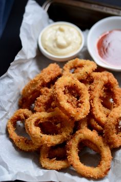 onion rings with dipping sauces on the side