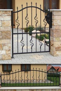 an iron gate is shown with different angles and shapes to match the house's exterior