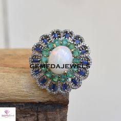 Genuine Multi Gemstone Ring, Pave Diamond Jewelry, 925 Silver Opal Ring, Emerald Tanzanite Ring, Diamond Silver Jewelry, Wedding Jewelry Gross Weight: 12.93 gram Diamond Weight: 1.15 cts Gemstone Weight: 12.45 cts Ring Size: 37X34 MM NOTE:- All The Products Are Designed And Manufactured In My Workshop By Me & My Team. Shown Products Are Purely Handmade. Custom Orders Are Open Handly Accepted. We Are the Perfect Choice For Any Custom Jewelry Manufacturing. For Bulk Orders Please Message me. V Fusion Style Round Opal Ring, Green Moonstone Wedding Ring, Wedding Emerald Ring With Gemstone Accents, Silver Opal Ring With Stones, Green Moonstone Gemstone Ring For Wedding, Green Moonstone Ring For Wedding, Fusion Style Multi-stone Gemstones For Wedding, Fusion Style Emerald Ring For Anniversary, Fusion Style Round Sapphire Ring For Anniversary