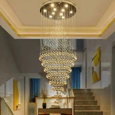 a large chandelier hanging from the ceiling in a room with marble floors and stairs