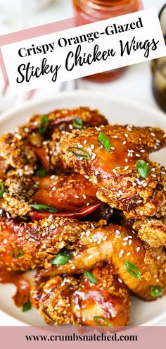 crispy orange - glazed sticky chicken wings on a white plate with text overlay