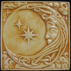 a ceramic tile with an image of the moon and stars