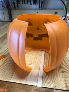 a pumpkin shaped vase sitting on top of a wooden table