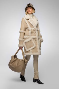 Women's Shearling B7 Bomber Leather Coat In Beige Add a touch of elegance to your winter wardrobe with our women's shearling b7 bomber leather coat in beige. Crafted from genuine sheepskin leather with a semi-aniline finish, best shearling leather coat features a cozy faux shearling inner shell for warmth. The button closure, turn-down fur collar, and open hem cuffs with fur accents enhance its sophisticated design. Practical and stylish, it includes one inside pocket and two side pockets. The refined beige color makes this coat a versatile choice for any cold-weather occasion. Outer Shell: Genuine Leather Leather Type: Sheepskin Leather Finish: Semi-aniline Inner Shell: Faux Shearling Closure Style: Button Collar Style: Turn Down Cuffs Style: Open Hem With Fur Inside Pockets: One Outside Beige Shearling Fur Coat For Fall, Fall Beige Shearling Fur Coat, Luxury Shearling Fur Coat For Fall, Luxury Sheepskin Fur Coat For Fall, Luxury Beige Outerwear With Pockets, Cream Shearling Fur Coat For Fall, Luxury Cream Fur Coat With Faux Fur Lining, Beige Shearling Outerwear For Cold Weather, Beige Shearling Outerwear With Faux Fur Lining