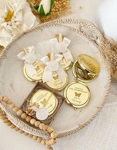 some gold and white tags are on a glass plate with flowers in the back ground