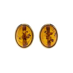 These oval cabochon earrings feature Baltic amber set in yellow gold, adding warmth to any outfit. Classic Yellow Oval Earrings, Classic Oval Cabochon Clip-on Earrings, Classic Amber Earrings For Formal Occasions, Classic Oval Clip-on Earrings With Polished Finish, Gold Oval Cabochon Clip-on Earrings, Elegant Amber Oval Earrings, Gold Oval Cabochon Earrings With Polished Finish, Classic Yellow Gold Oval Cabochon Earrings, Estate Wedding Ring