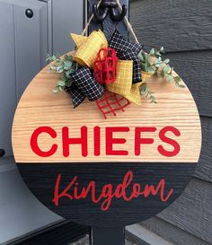 a sign that says chefs kingdom hanging from the side of a building with decorations on it