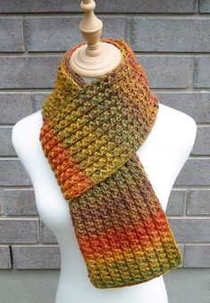 This beautiful hand knitted scarf is made with very Soft Acrylic Yarn. The pattern  looks the same on both sides. The scarf can be worn in multiple ways. Amazing colors for the fall/winter season: shades of burnt orange, yellow, brown, and green. The colors may appear slightly different on different monitors. Measures: 67" (170 cm) long x 6" (15-16 cm) wide. From a smoke-free home. Care instructions: Hand wash in cool water and dry flat. Crochet Acrylic Yarn Scarves For Fall, Fall Crochet Scarves In Acrylic Yarn, Fall Crochet Scarf In Acrylic Yarn, Fall Crochet Acrylic Scarves, Hand Knitted Yarn Patterns For Fall, Fall Crochet Yarn Scarf, Mens Knitted Scarf, Chunky Knit Scarf, Scarf Autumn