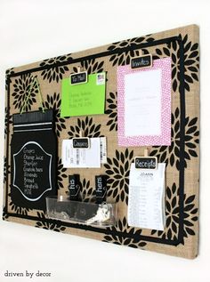 a bulletin board with notes and magnets attached to the back of it, hanging on a wall