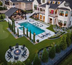 an aerial view of a large house with a pool and patio in the foreground