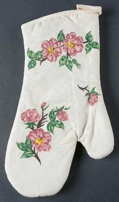 a white oven mitt with pink flowers on it