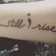 a person with a tattoo on their arm that says still rise and an image of a spoon