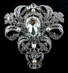 "An old hollywood glamour statement wedding broach featuring ornate and detailed Victorian motifs. This stunning bridal brooch is made of clear swarovski crystals with handwired pearls, set on silver rhodium finish. Broach is big and wide, measures about 3 1/4\" (8.5cm) x 3 1/2\" (9cm) at its widest. View other Victorian inspired accessories https://etsy.me/2uAseFc View all brooch pins at https://etsy.me/1eEBStU * Bride's pics are credit and courtesy of our satisfied bride" Elegant Pearl Jewelry, Wedding Brooches, Bridal Brooch, Pearl Jewelry Wedding, Bridal Fashion Jewelry, Victorian Wedding, Wedding Brooch, Vintage Style Wedding, Crystal Brooch