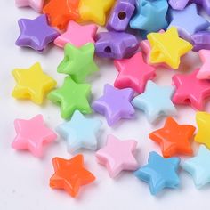 many different colored stars on a white surface