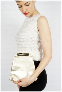 "S T R A I G H T T A L K ▲ Circa: 50s/60s ▲ Label: ▲ Color: Metallic Gold Foil ▲ Condition: Very Good D E T A I L S ▲ Cute vintage metallic platinum gold clutch with optional gold chain shoulder strap ▲ Shoulder chain can fold into the inside of the purse to make it a clutch ▲ Strong kiss lock closure ▲ Satin pink lining ▲ Small interior pocket C O N D I T I O N ▲ Very Good Flaws noted: minor indentations in the gold foil, lining is a little dirty/shows some wear M E A S U R E M E N T S ▲ Width Classic Party Clutch With Gold-tone Hardware, Elegant Gold Clutch For Spring, Classic Evening Bag With Chain Strap For Parties, Classic Chain Strap Evening Bag For Parties, Classic Party Evening Bag With Chain Strap, Spring Evening Clutch With Chain Strap, Vintage Formal Bags For Spring, Vintage Formal Bag For Spring, Formal Vintage Bags For Spring