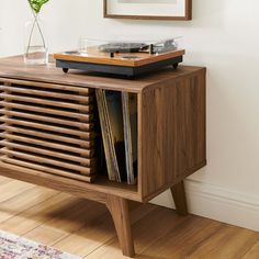 a record player on top of a wooden cabinet