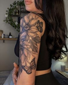 a woman with a butterfly tattoo on her arm