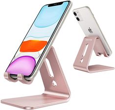 an iphone is sitting on top of a metal stand with one phone in it's holder