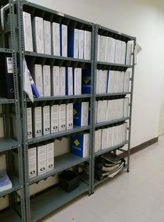 the shelves are filled with files and folders