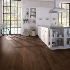 a kitchen with wood floors and white cabinets