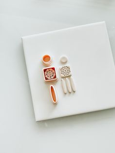 a white plate topped with different types of utensils on top of a table