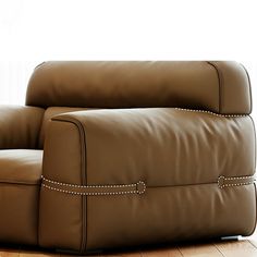 a brown leather recliner sitting on top of a hard wood floor