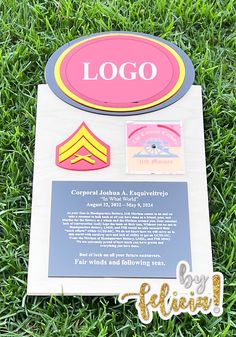 a sign in the grass that says logo