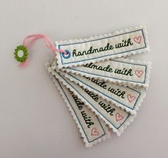 four handmade tags with words on them