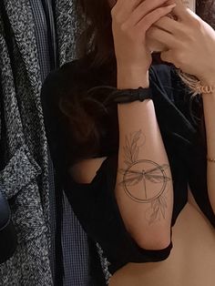 a woman with a tattoo on her arm