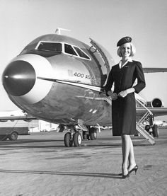 a woman standing in front of an airplane