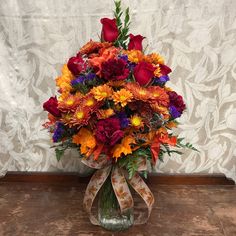 a vase filled with lots of colorful flowers