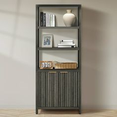 a bookshelf with three shelves and two vases on the top one shelf