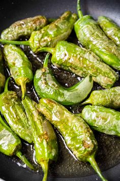 green peppers are being cooked in a wok