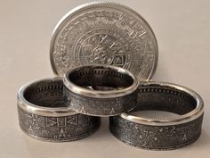 I take a 1/2 Troy Oz BU .999 pure silver Aztec Calender Coin and made this it into coin rings like you see in the photos and in the video. Theses ring have fine details everywhere on the outside. I use a Jeweler's strength patina to darken the non raised details on the coin ring. Then really polish the silver raised areas to bring out a 3-D affect. Please see all photos as this looks like the ring you will receive.  Thank you for looking at my rings. Aztec Coin, Coin Rings, Coin Ring, Christmas Wedding, Handmade Artisan, Pure Silver, Wedding Anniversary, Band Rings, 3 D