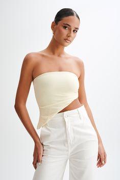 Exude eleganceThe DONATA Slinky Strapless Top is a chic and stylish choice for those looking to add a dash of elegance to their wardrobe. This top features a strapless design that highlights the shoulders and collarbone, making it an excellent option for both casual and formal occasions. The asymmetrical hem adds a contemporary and artistic flair, offering a unique silhouette that sets it apart from traditional tops. Side gatherers provide a flattering ruched effect, enhancing the body's curves Traditional Tops, Lemon Sherbet, Capsule Wardrobe Basics, Maxi Dress Sale, Beige Dresses, Swimwear Sale, Crepe Dress, High Waisted Trousers, Asymmetrical Hem