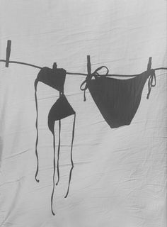 an image of some clothes hanging on a line with wires attached to the clothesline