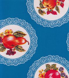 three plates with fruit on them sitting on a blue tablecloth covered in doily