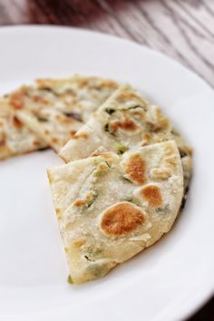 two pieces of flat bread on a white plate