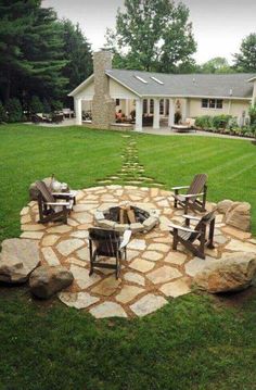 an outdoor fire pit with chairs around it